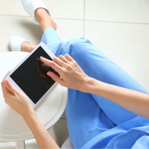 a nurse looking at a tablet